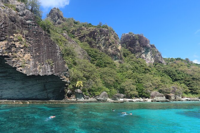 Reef water below the cliffs on a Fiji island day cruise